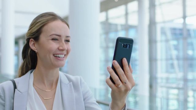 beautiful business woman walking in airport using smartphone having video chat talking to client discussing work successful female executive with mobile phone 4k