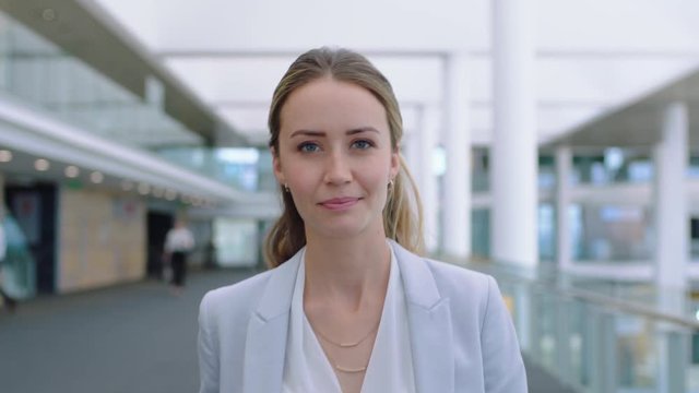 confident business woman smiling enjoying successful corporate career independent female executive walking in airport lobby wearing stylish suit with confidence 4k footage