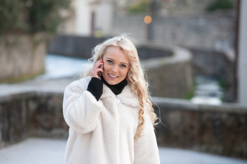 Attractive blond woman in a stylish winter coat