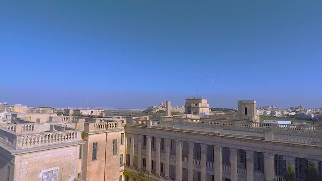 Pigeons flying in front of school