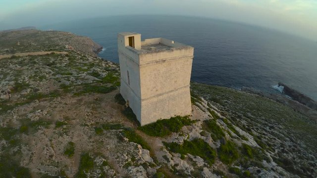 Aerial view of stone tower with sea in the background