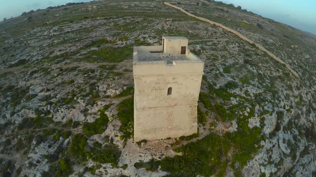 Aerial view of stone tower with sea in the background