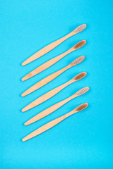 Bamboo toothbrushes on blue background. Plastic free concept.