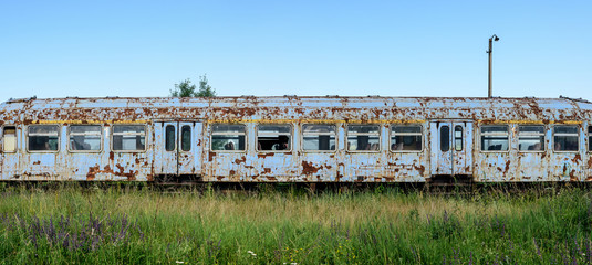 Old rusty railway wagon whit broken windows. Old abandoned track, siding with dirty old trains. Old railway tracks.