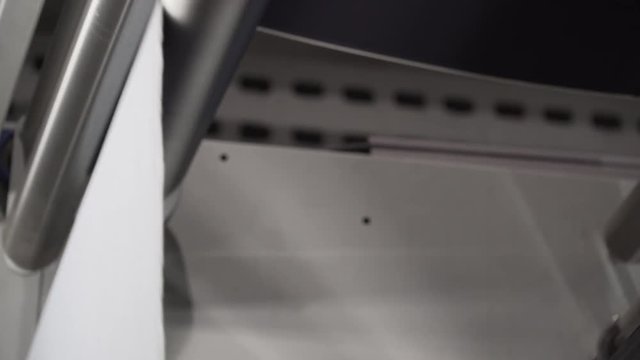 Gorgeous static shot of an automated machine in a denim production mill.