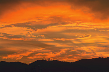 Beautiful colorful sunset clouds over mountains.