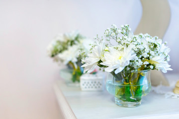 beautiful flowers, white chrysanthemums in weight on the fireplace, places for text