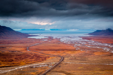 View over beautiful Adventdalen from above coal mine number 7, cloudy day in the arctic tundra of...