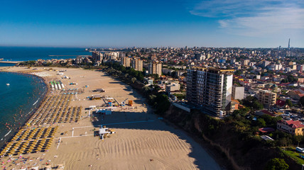 Fototapeta premium Aerial view of public beach in Constanta, popular tourist place and resort on black sea in a Romania. Also, in constanta is placed largest harbor in Romania.