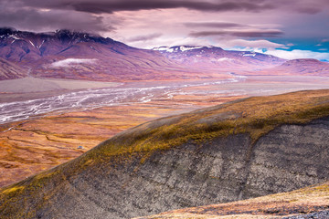 View over beautiful Adventdalen fjord from above, Riverbed bedween mountains, the arctic tundra of...