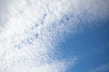 Beautiful view of hight blue sky with clouds. Happiness and freedom. Concept of climate, weather, environment. Background for design. Copy space.