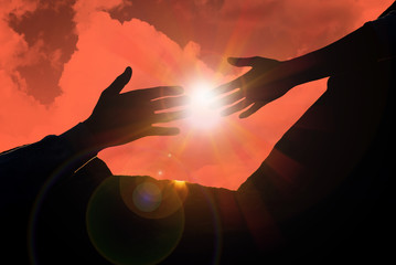 Man reaching for woman's hand at sunset, closeup. Help concept