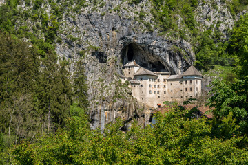 Fototapeta na wymiar Famous castle of Predjama built into a cave in mountain in Slovenia