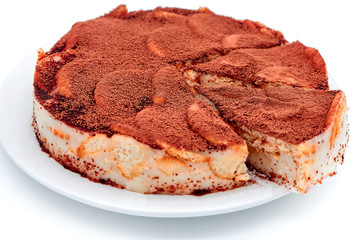 Pie sprinkled with cocoa powder on a plate. Chocolate cake crackers on isolated white background. Chocolate cream pastry, isolate background.