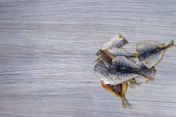 Salted fish lying on a wooden table