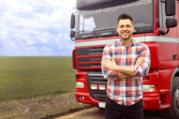 Portrait of driver at modern truck outdoors. Space for text