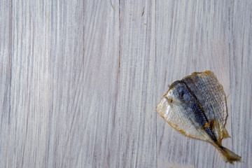 Salted fish lying on a wooden table