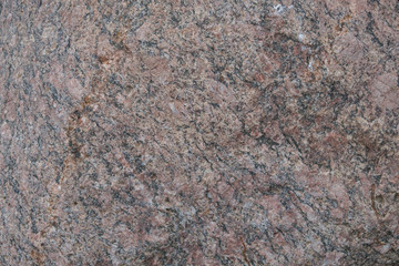 Background of natural stone. A snapshot of granite boulder (Latin 