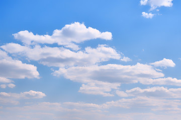 Fototapeta na wymiar Cloudy sky in clear weather. Cumulus cloud on a sunny winter day. White clouds against a blue sky.