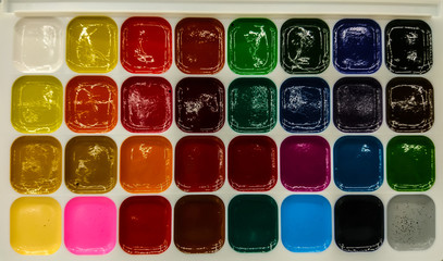 Colored oil paints for children of different colors.