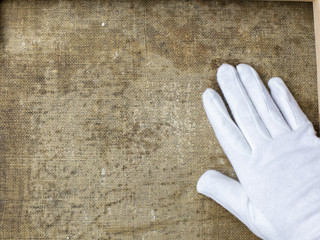 restoration and conservation of a very old canvas, restoration of a painting, restorer at work, place for text