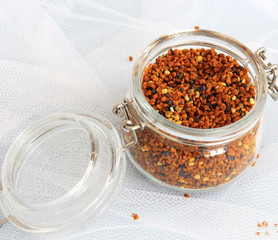 pollen in a glass jar on a white background