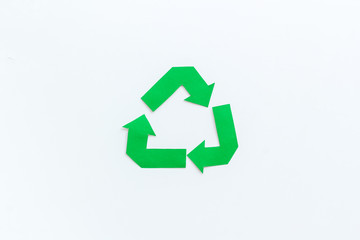 Obraz premium Green recycling sign for eco concept on white background top view