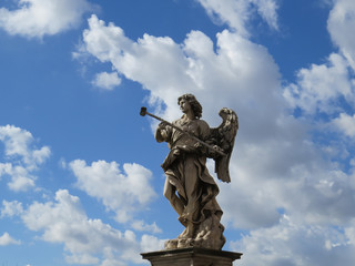 Fototapeta na wymiar angel statue with blue sky and clouds