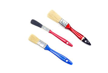 Three brushes for painting a house on a white background