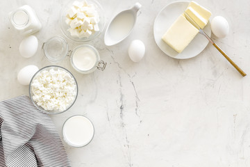 Eggs, butter, milk, yougurt, cottage for natural farm products yougurt marble background top view monochrome copyspace