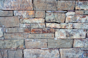Close-up surface of the old dirty fence made of natural stone and cement.