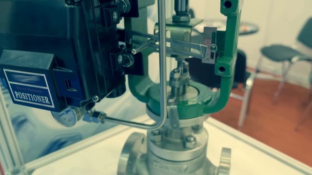 Industrial ball valve is automatically controlled by positioner on top mounted. A new sample is presented for review at the exhibition. Shot in motion