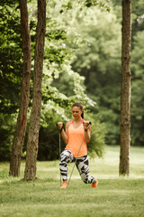  A beautiful fitness girl trains in the park