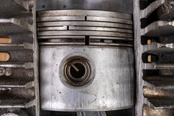 Piston of an internal combustion engine in a cut aluminum cylinder. Internal view of the internal combustion engine.