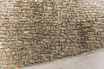 Old stone wall on background. Brick wall with ancient masonry. Full frame of rich and varied...