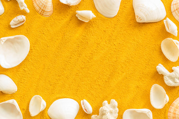 shells frame and seaside background for blog or desktop on yellow sand top view mockup