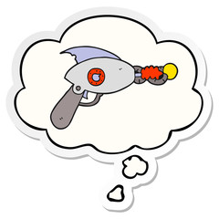 cartoon ray gun and thought bubble as a printed sticker