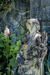 Obraz premium Female stature in garden.