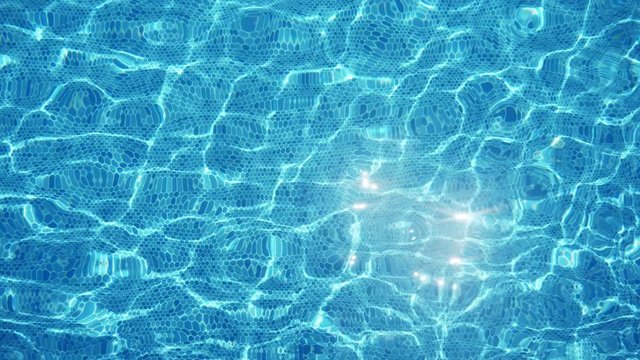 Transparent water shining cheerily in a paddling pool on a sunny day in slo-mo 