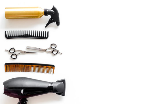 Combs, dryer and hairdresser tools in beauty salon work desk on white background top view mockup