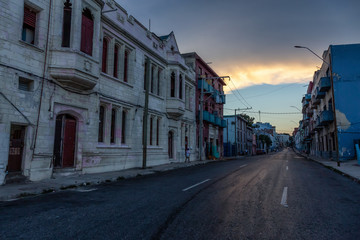 Street View of the Old Havana City, Capital of Cuba, during a cloudy and sunny sunset.