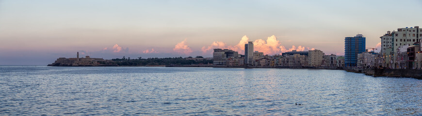 Fototapeta premium Panoramic view of the Old Havana City, Capital of Cuba, during a colorful cloudy sunset.