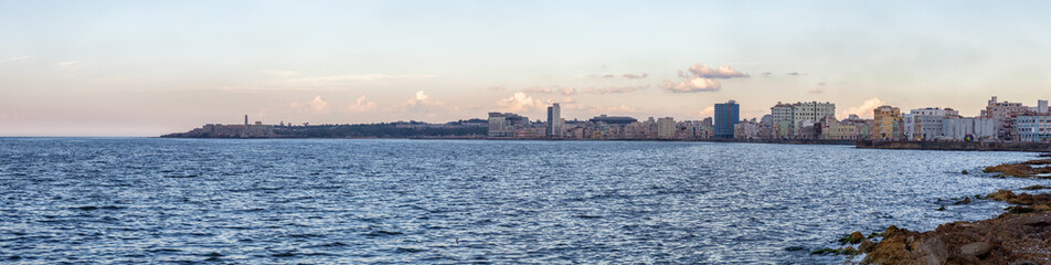 Naklejka premium Panoramic view of the Old Havana City, Capital of Cuba, during a colorful cloudy sunset.