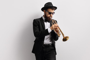 Bearded guy playing a trumpet
