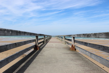 Fototapeta na wymiar Bridge and Ocean Omaha Beach
