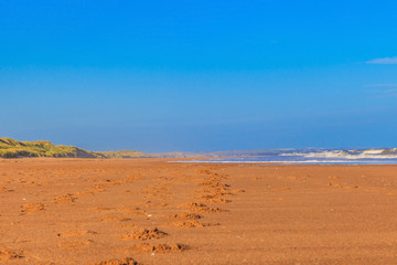 Fototapeta na wymiar Beach in Scotland with foottracks in the sand