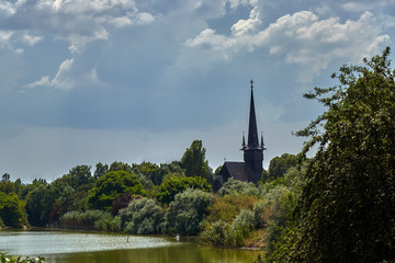 Fototapeta premium A church behind the trees