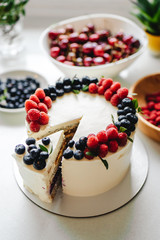 Close up. Creamy mascarpone cheese cake with strawberry and winter berries. New York Cheesecake. Close up. Christmas dessert. Healthy food. Creative atmospheric decoration.