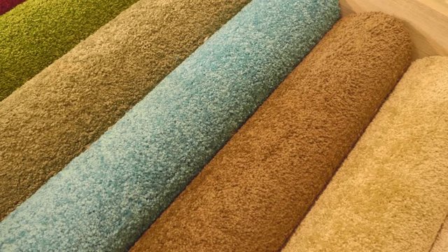 Samples Of Different Colors Of Carpet On The Shop Rack. Shot In Motion