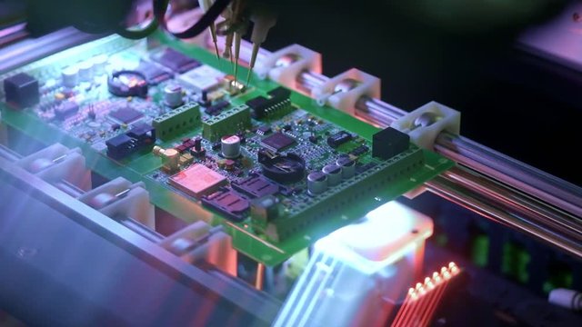 Electronic circuit board production. Automated Circut Board machine Produces Printed digital electronic board. Electronics contract manufacturing. Manufacture of electronic chips. High-tech.